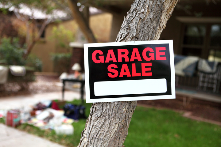 Garage sale fundraiser sign stapled to a tree