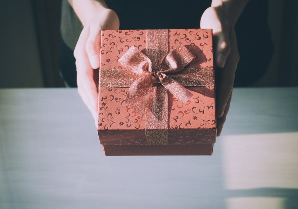 person handing out appreciation gifts for volunteers