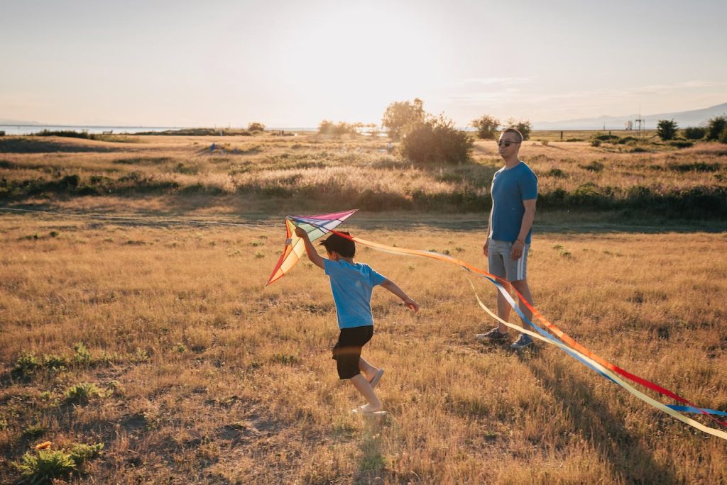 a father and son flying kites for spring fundraising ideas