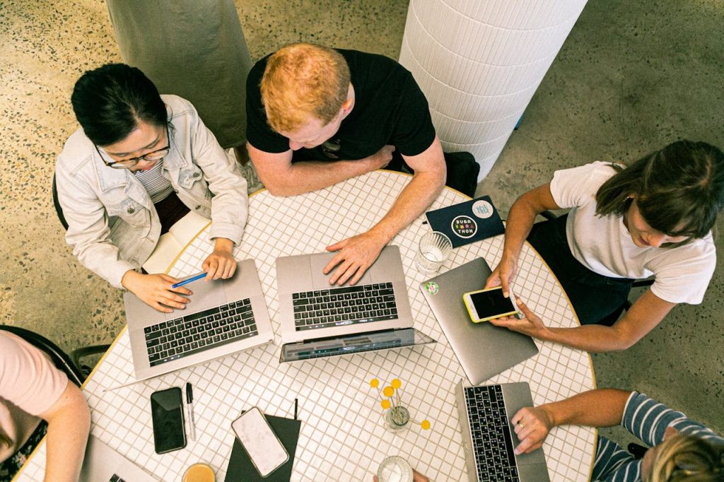 group of people on laptops meeting to discuss nonprofit marketing strategies