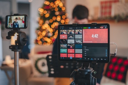 smartphone and monitor with person in background set up a live stream for a Giving Tuesday campaign