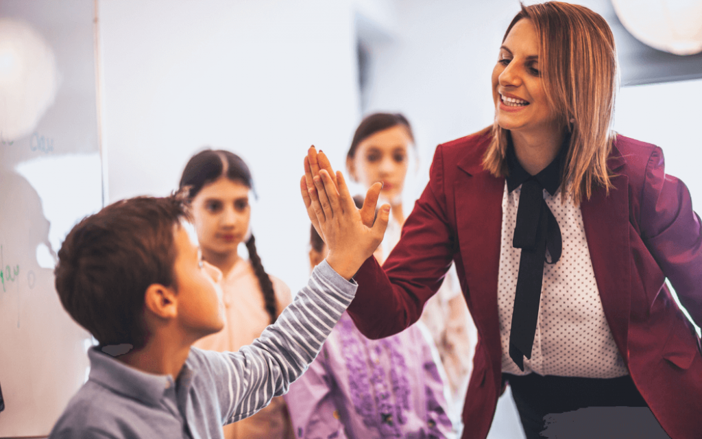 Woman high-fiving young mentee