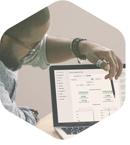 Nonprofit employees comparing donation form performance in Qgiv.