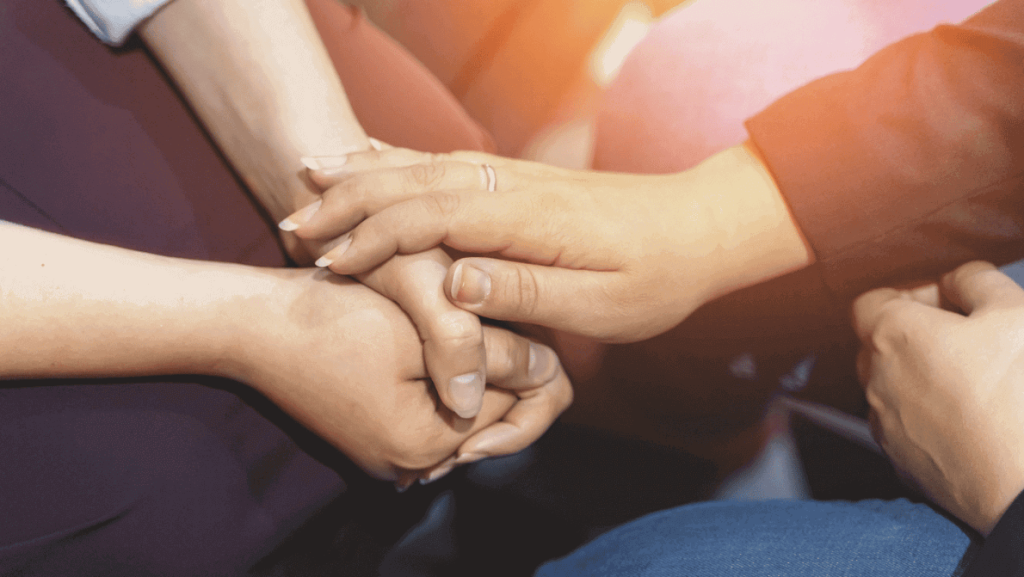 close up of two people touching hands